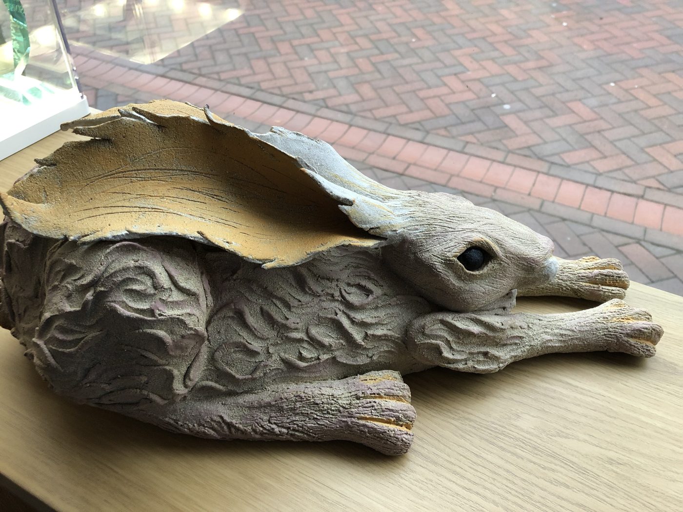 Large finished clay hare lying in the shop window